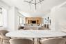 Open-concept interior featuring light wood-finish flooring and a central chandelier