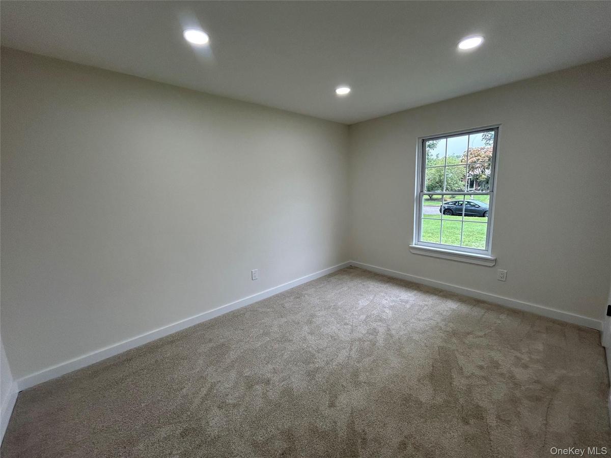 Bedroom with recessed lighting and new carpeting