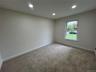 Bedroom with recessed lighting and new carpeting