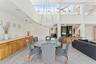 Dining room with ceiling fan and a towering ceiling