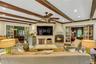 Southwest facing great room oozing with natural light, featuring beam ceiling, recessed lighting, french doors to den and back door leading to brick p