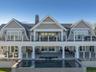 Back of property with a gambrel roof, french doors, and a patio