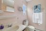 Bathroom featuring vanity, baseboard heating, and curtained shower