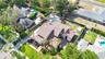The backyard is fully enclosed by a block wall and secured with wrought iron gates.