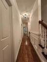 This is a view of the 3rd Floor Hallway, with entrances to 3 bedrooms, hall bath and staircase up to 4th floor. Notice the gorgeous hardwood flooring 