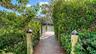 Private dock access through lush landscaping