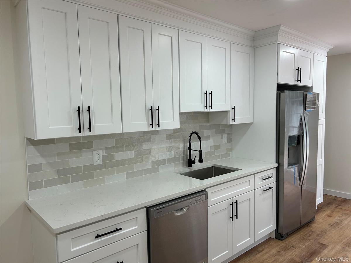New soft close cabinets, Quartz countertops and stainless steel appliances