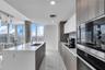 Sleek open kitchen with breakfast bar seating and premium finishes