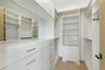 Walk in closet with light wood-style floors