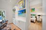 The primary suite is located just off the living room hidden behind a custom bookcase doorway