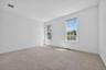 The first of two second floor bedrooms offers generous space and a blank slate for your own style. Fresh carpeting and your paint color of choice woul