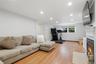 Recessed lighting, wood-finish flooring, and a window with exterior visibility