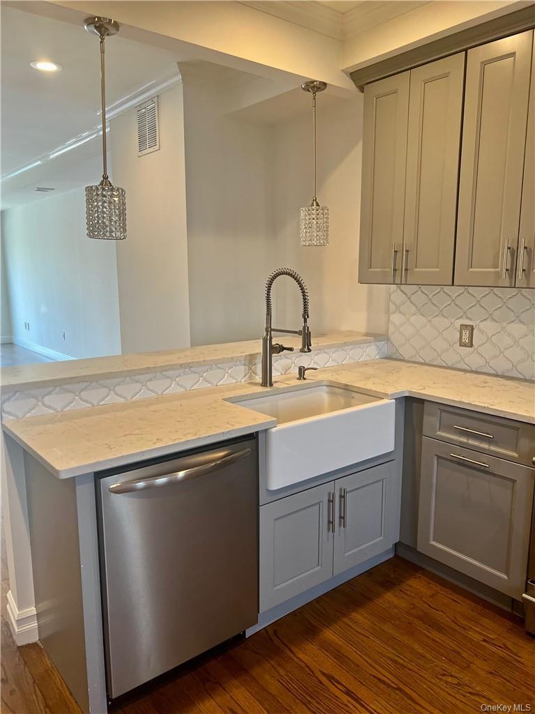 Another view of the huge, chef's kitchen, featuring farm-style sink, stainless steel appls, quartz counter tops and beautiful gray cabinets! There is 