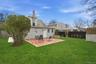 Rear view of house featuring a patio, a fenced backyard, and a chimney