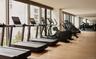 Exercise room with expansive windows and wood finished floors