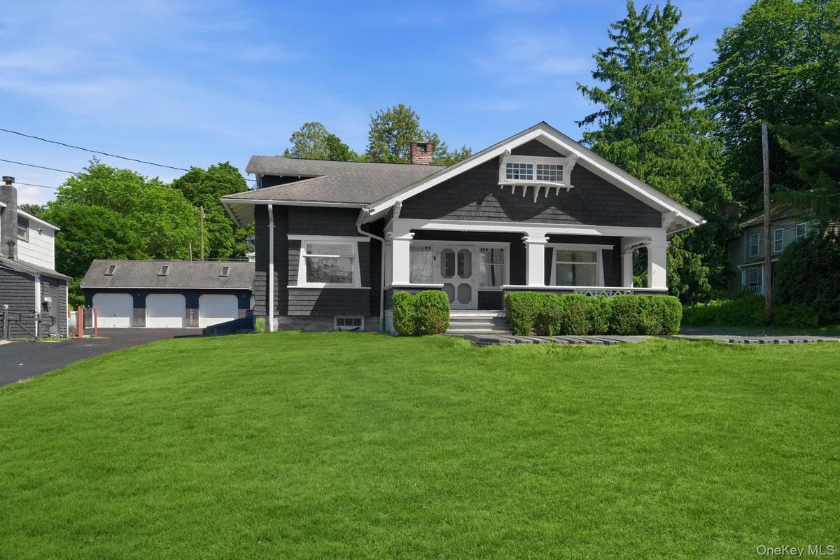 A distinguished Craftsman residence blending historic character with lasting investment value and a view of the 4 car detached garage.