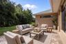 Extended pavered lanai in backyard provides great entertaining space and phenomenal views - virtually staged