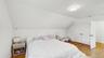 Bedroom with visible vents, baseboards, a closet, light wood-style floors, and vaulted ceiling
