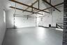 Garage featuring a garage door opener and baseboards
