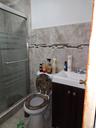Full bath featuring vanity, a shower stall, tile walls, and tile patterned floors