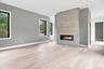 Spacious interior featuring a contemporary linear fireplace set within a textured accent wall