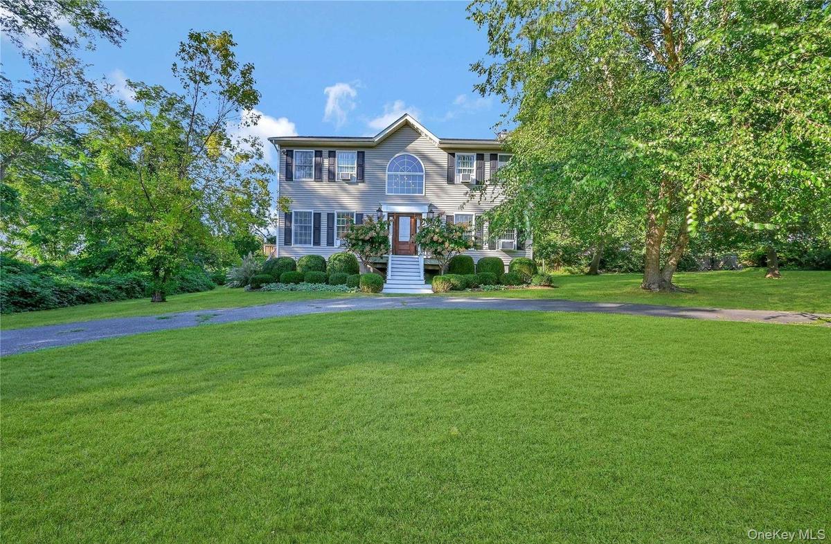 Colonial house with a front yard and driveway