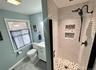 Full bathroom with a shower stall, light tile patterned flooring, and vanity