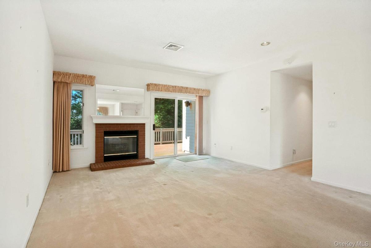 Living room with fireplace*,recessed lights & view to hallway/laundry/ bedroom area