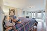 Bedroom featuring connected bathroom, french doors, hardwood / wood-style floors, and ornamental molding