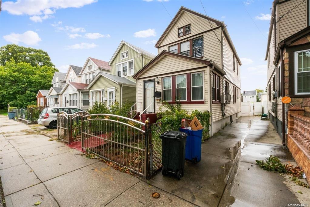 View of front of property with a gate and a residential view