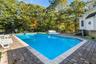 View of pool featuring a patio and a diving board