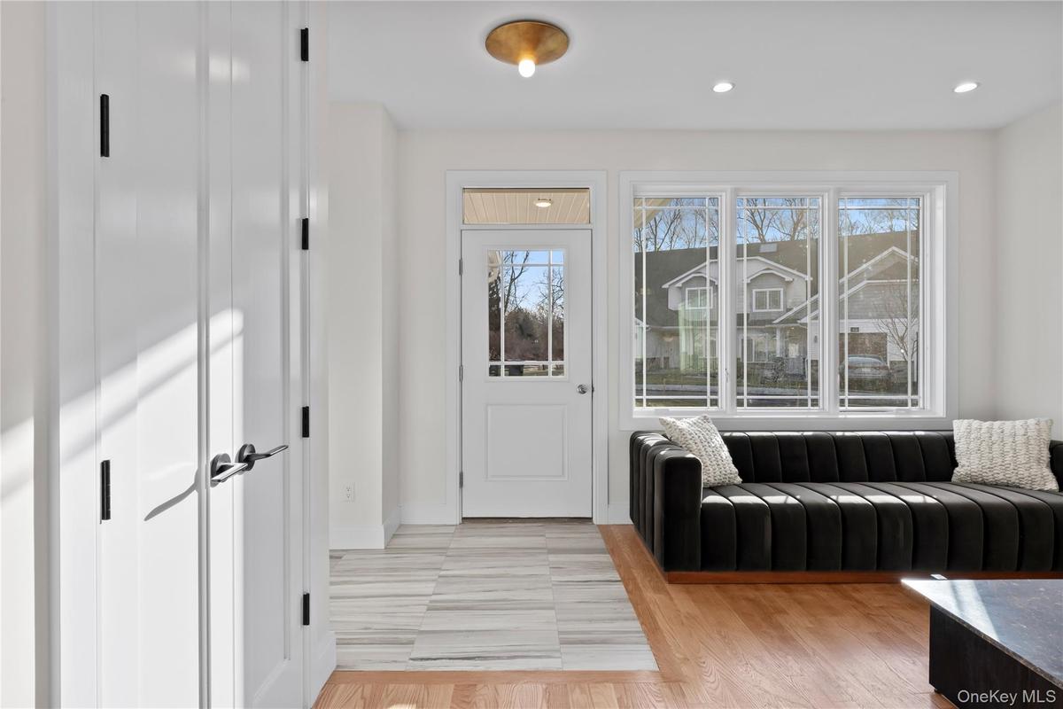 Foyer entrance with light wood-style flooring and recessed lighting