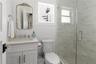 Bathroom with a shower stall, vanity, and toilet