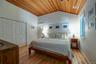 Master Bedroom with natural wood flooring, skylights & storage.