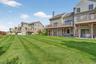 Rear view of property with a yard, a chimney, a patio area, a residential view, and a wooden deck