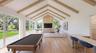 Vaulted beam ceiling in the recreation room that provides seamless lines with the pool and deck