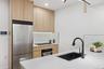 Kitchen featuring high end fridge, wall oven, light brown cabinets, a sink, and recessed lighting