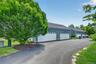 The spacious two-car garage includes lofted storage, offering plenty of room for vehicles, outdoor supplies, seasonal items, and more.