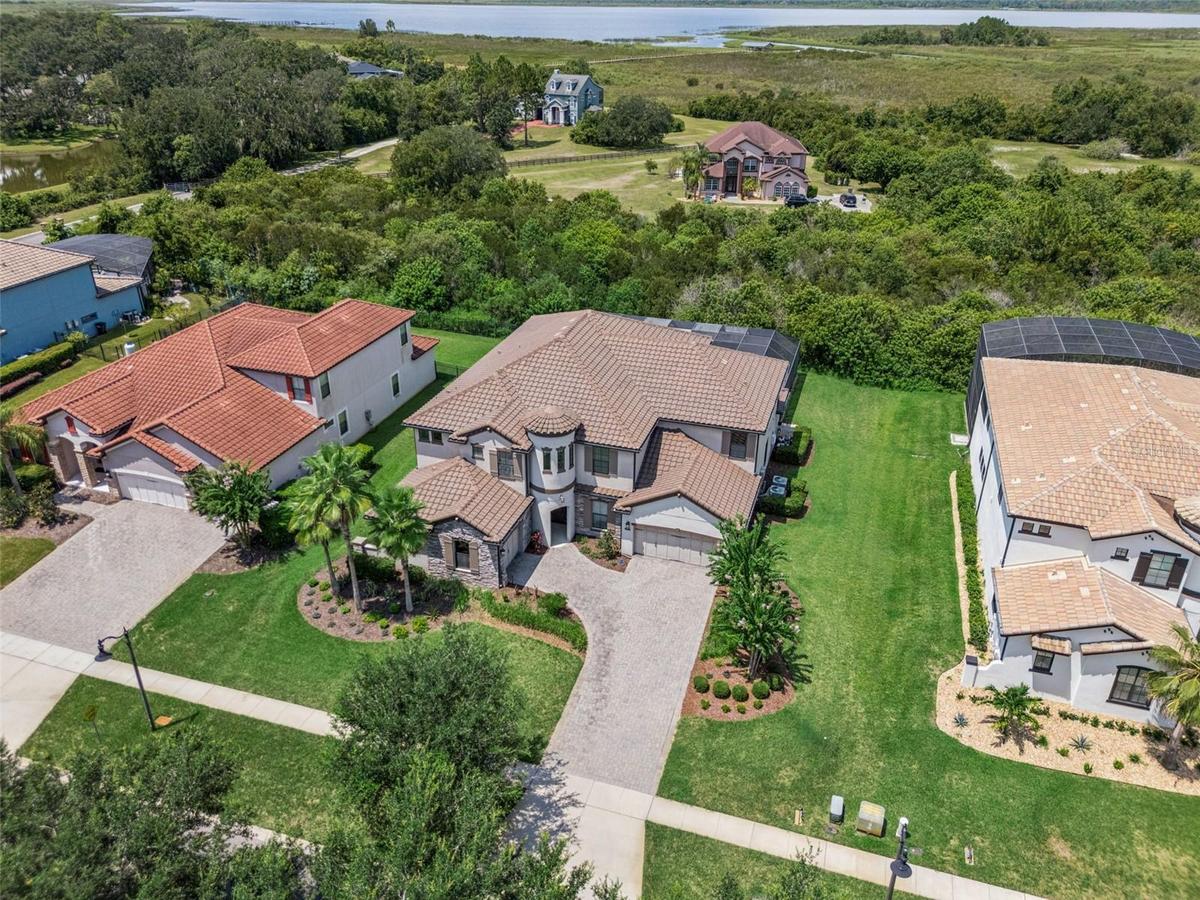 Luxury, privacy and LAKE ACCESS define this exceptional 6-bedroom, 5.5-bath CUSTOM POOL HOME in Waterside Vista, an intimate GATED ENCLAVE of just 24 