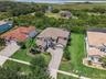 Luxury, privacy and LAKE ACCESS define this exceptional 6-bedroom, 5.5-bath CUSTOM POOL HOME in Waterside Vista, an intimate GATED ENCLAVE of just 24 