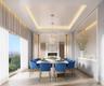 Dining space featuring a chandelier, a warm lit fireplace, a raised ceiling, and light wood-style floors