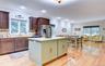 Legal accessory apartment: Open-concept living space featuring wood flooring, recessed lighting, and crown molding