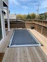 View of swimming pool with a wooden deck