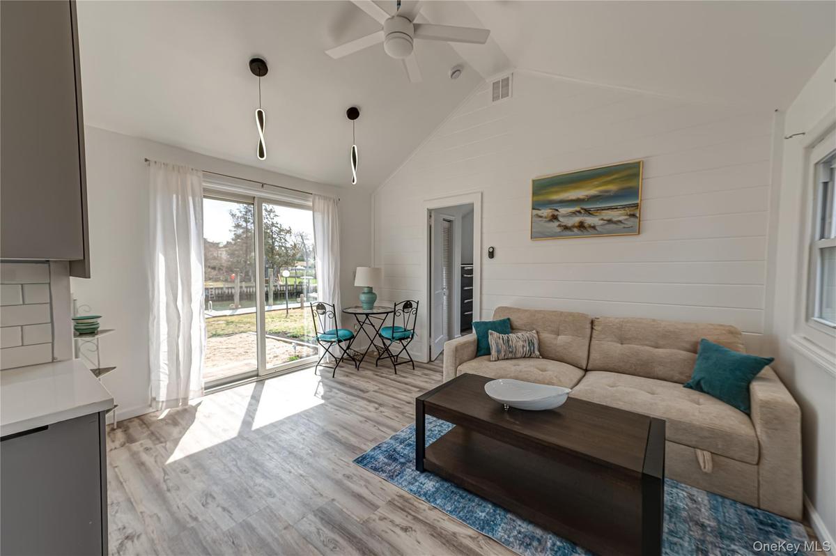 large open room with sunshine and a view of the water