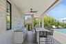 Wooden deck featuring grilling area, a ceiling fan, an outdoor pool, and a sink