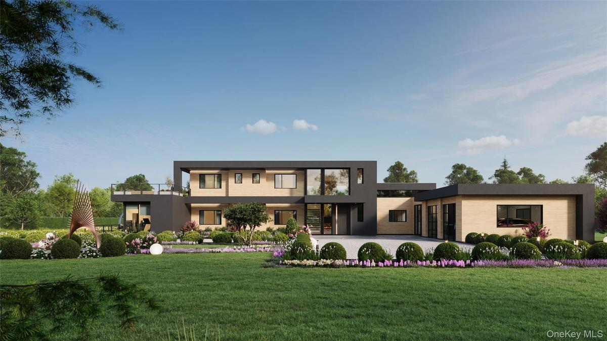 A striking modern façade defined by clean architectural lines, layered landscaping, and a custom pivot entry. The attached two-car garage is seamlessl