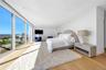 Bedroom featuring light wood-type flooring and a water view