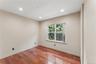 Bedroom featuring wood-finish flooring, recessed lighting, neutral wall tones, and a multi-pane window with blinds