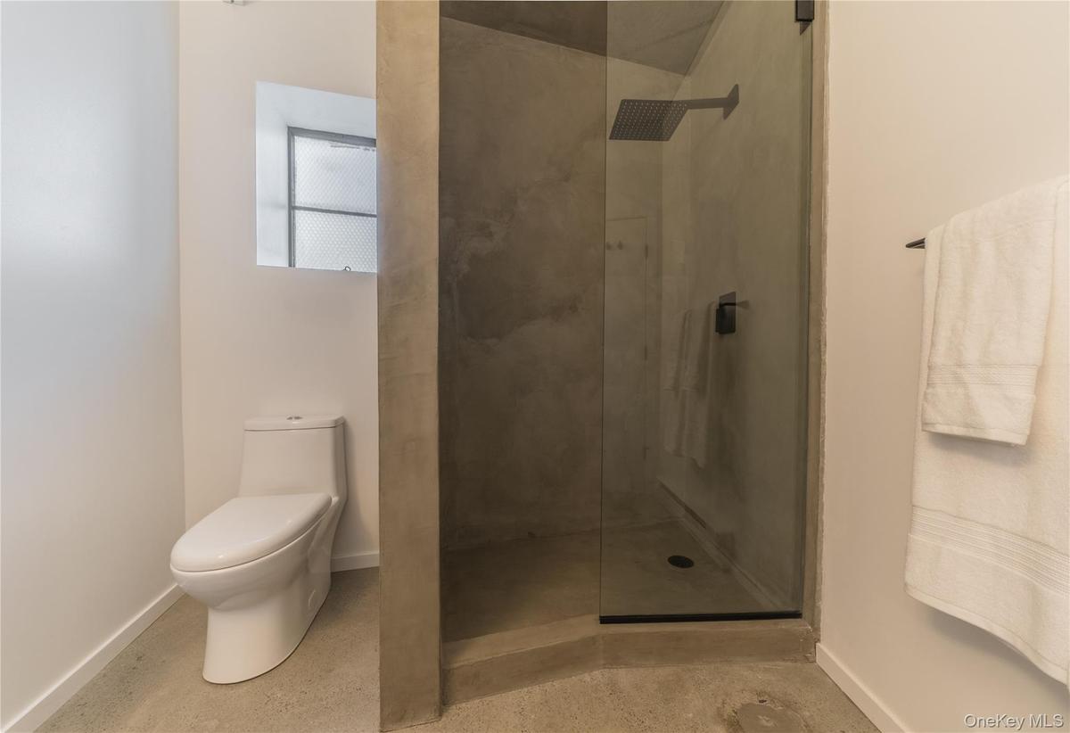Full bath with a stall shower and toilet