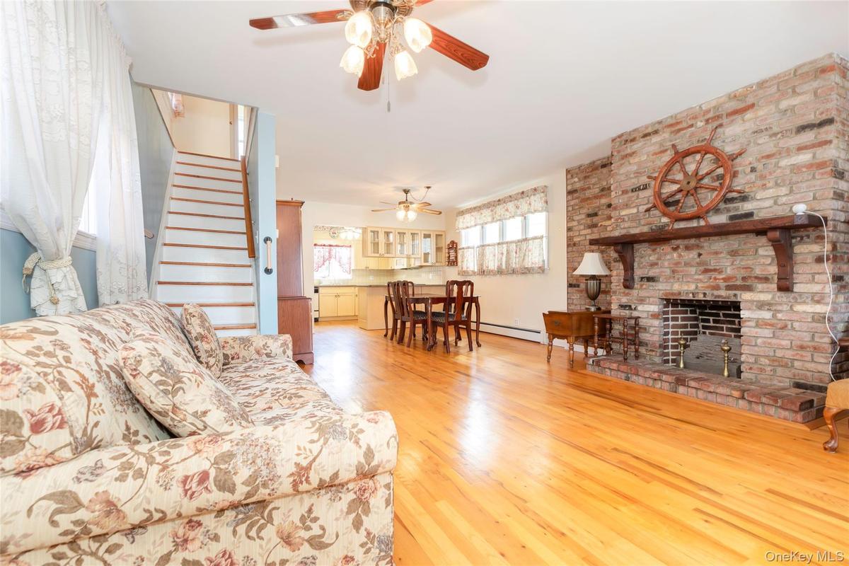 Open concept living room into dining room with gas fireplace